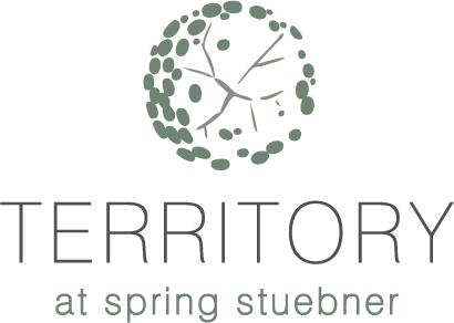 A logo with a tree and the words "TERRITORY at spring stuebner".